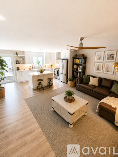 A living room with a brown couch and a white coffee table.