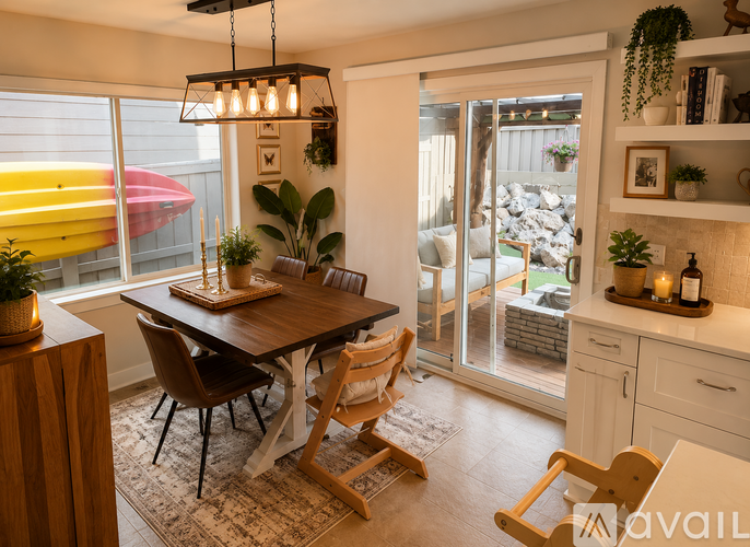 A dining room with a table and chairs.