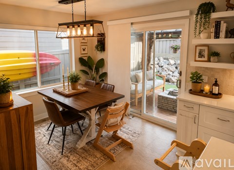 A dining room with a table and chairs.