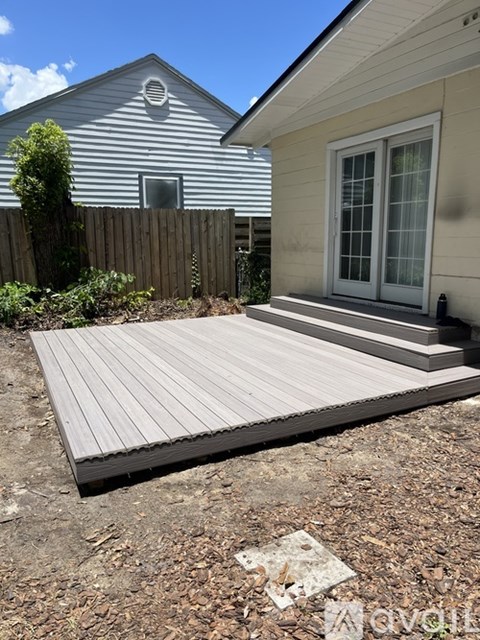 A wooden deck in front of a house.