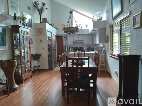 A dining room with a wooden table and chairs.