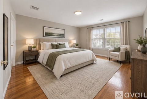 A bedroom with a large bed and a painting on the wall.