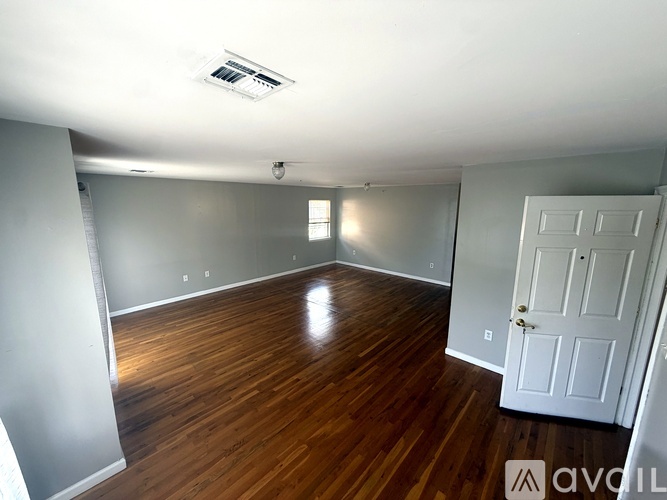 A room with wooden floors and a white door.