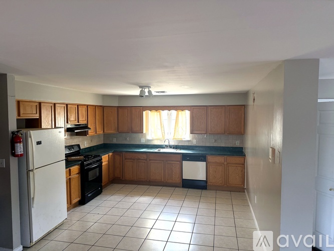 A kitchen with wooden cabinets and a white refrigerator.