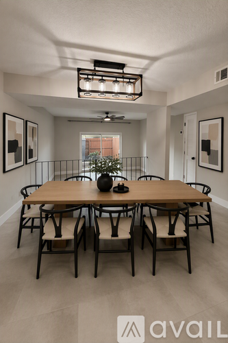A dining room with a wooden table and chairs.