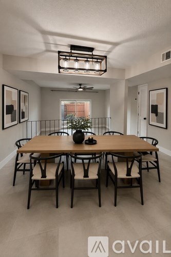 A dining room with a wooden table and chairs.
