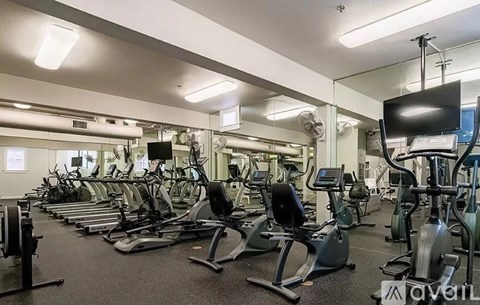A gym with treadmills, exercise bikes, and other equipment.