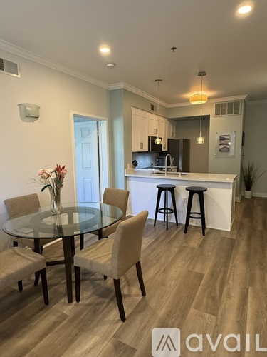 A dining room with a glass table and chairs.