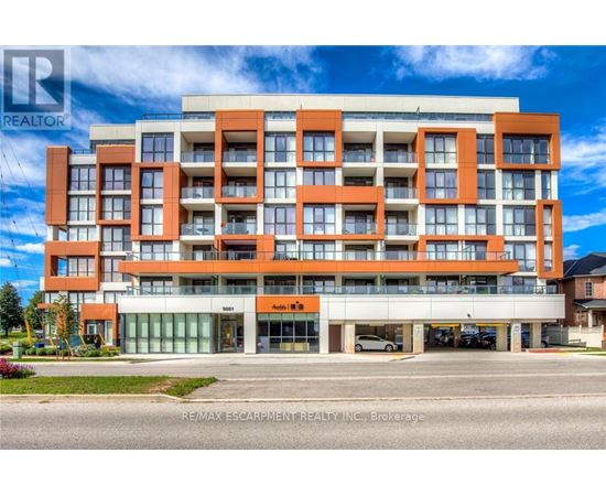 A multi-story building with a realtor logo on the top left corner.