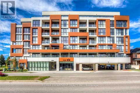 A multi-story building with a realtor logo on the top left corner.