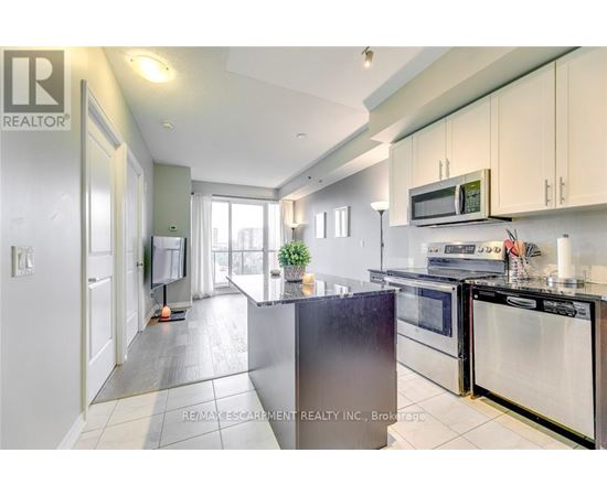 A kitchen with a stainless steel refrigerator and oven.