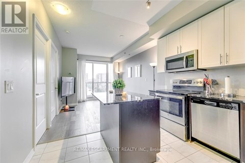 A kitchen with a stainless steel refrigerator and oven.
