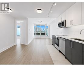 A kitchen with a sink, microwave, and oven.