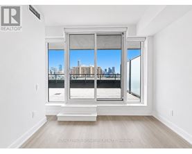 A room with a large window overlooking a cityscape.