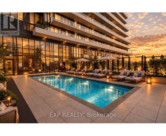 A large, modern building with a pool in front of it.