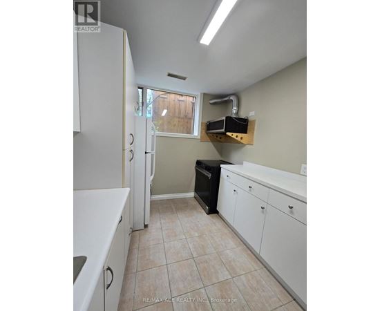 A kitchen with white cabinets and a black dishwasher.