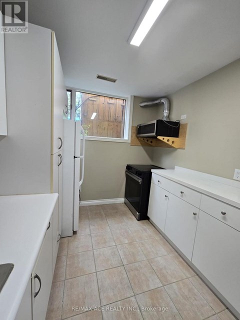A kitchen with white cabinets and a black dishwasher.
