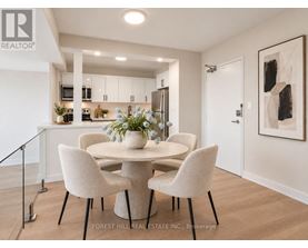 A dining room with a table and chairs.