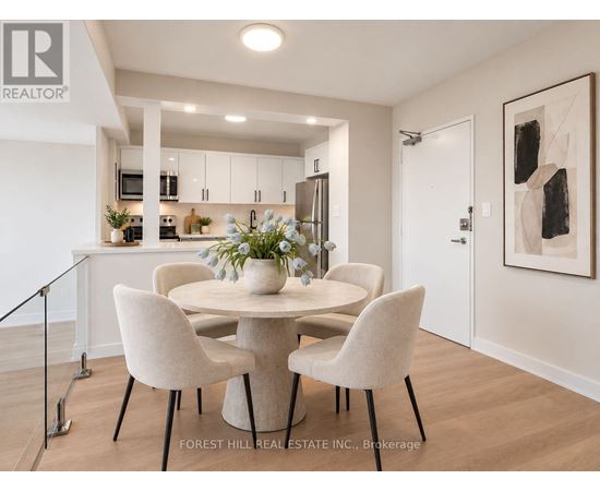 A dining room with a table and chairs.