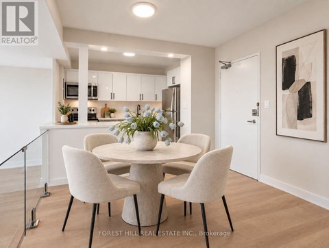 A dining room with a table and chairs.