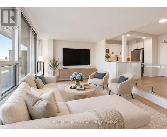 A living room with a white couch and a flat screen TV.