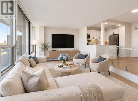 A living room with a white couch and a flat screen TV.