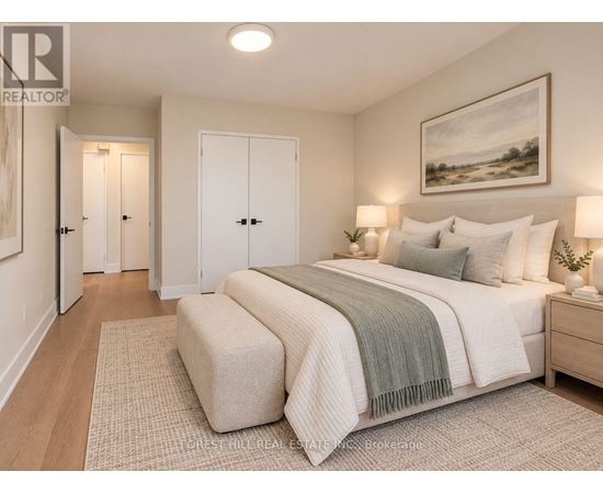 A bedroom with a large bed and a painting on the wall.