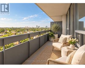 A balcony with a couch and a table with flowers on it.