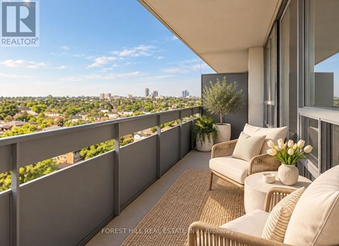 A balcony with a couch and a table with flowers on it.