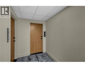 A hallway with a wooden door and a sign that says REALTOR.