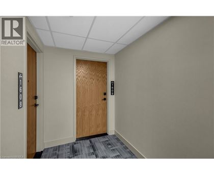A hallway with a wooden door and a sign that says REALTOR.