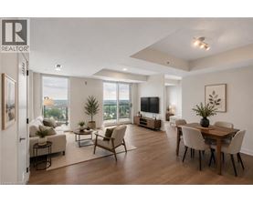 A well-lit, spacious living room with a dining area and a view of the city.