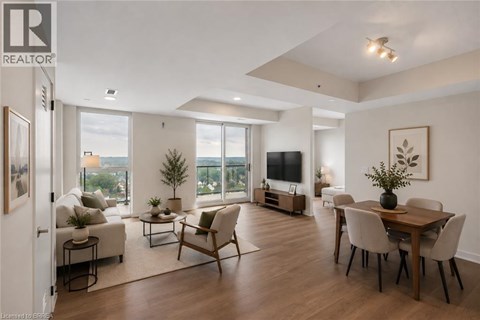 A well-lit, spacious living room with a dining area and a view of the city.