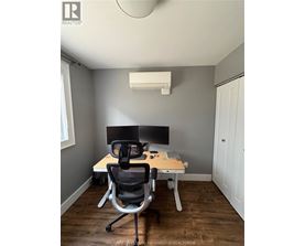 A room with a desk and a computer monitor.