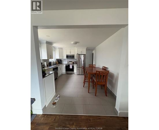 A kitchen with a table and chairs in the middle of the room.