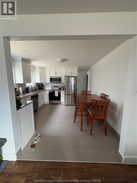 A kitchen with a table and chairs in the middle of the room.