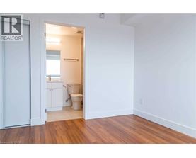 A bathroom with a toilet and sink is visible from a hallway.