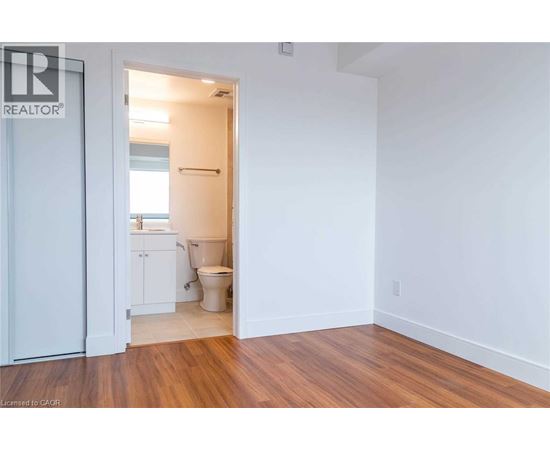 A bathroom with a toilet and sink is visible from a hallway.