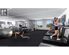 A woman is running on a treadmill in a well-equipped gym.