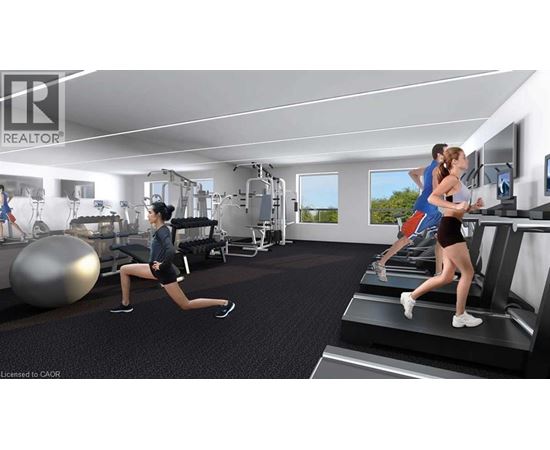 A woman is running on a treadmill in a well-equipped gym.