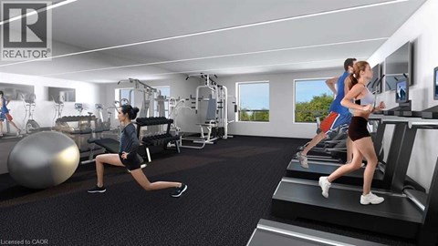 A woman is running on a treadmill in a well-equipped gym.