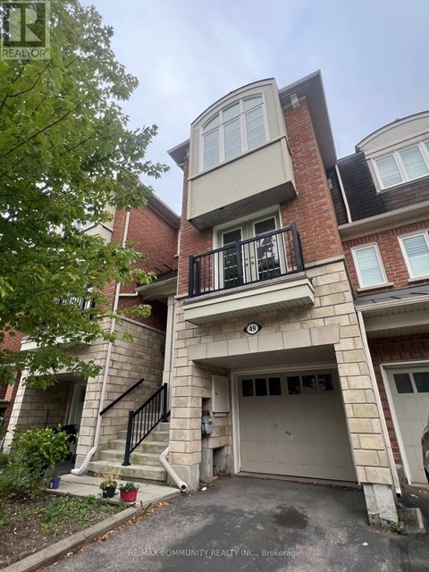 A multi-story residential building with a balcony on the second floor.