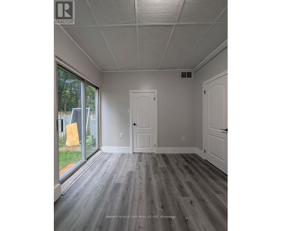 A room with a grey floor and white walls.