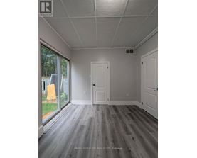 A room with a grey floor and white walls.