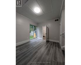 A room with a grey floor and white walls.