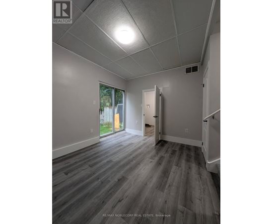 A room with a grey floor and white walls.