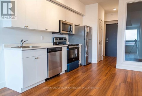 A kitchen with white cabinets and stainless steel appliances.