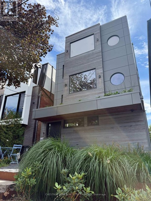 A modern house with a wooden exterior and large windows.