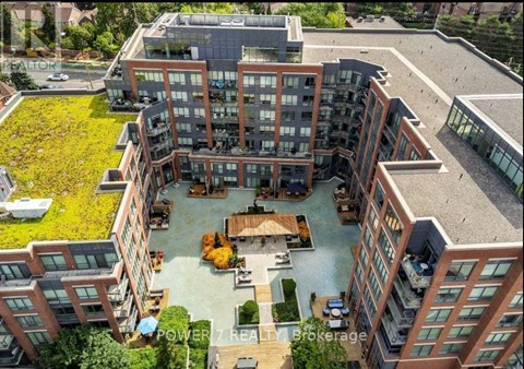 A modern building complex with a courtyard and a fountain.