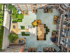 An aerial view of a courtyard surrounded by buildings with a sign that reads "POWER 7 REALTY Brokerage".